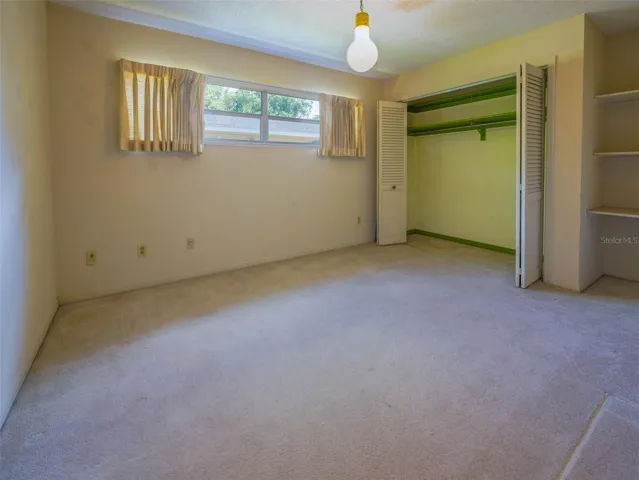Bedroom with double closet and built in shelving