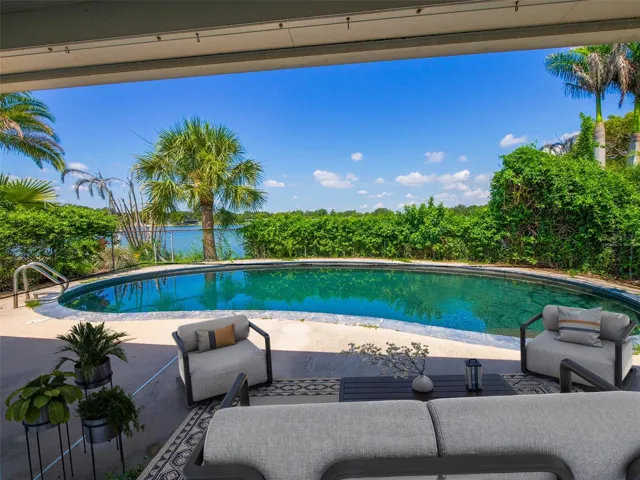 Virtually Staged covered patio overlooking the pool and Lake Giles