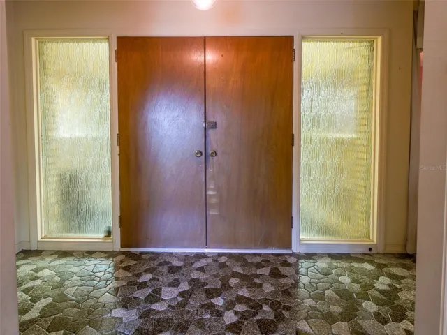 Entry foyer with paneled double doors