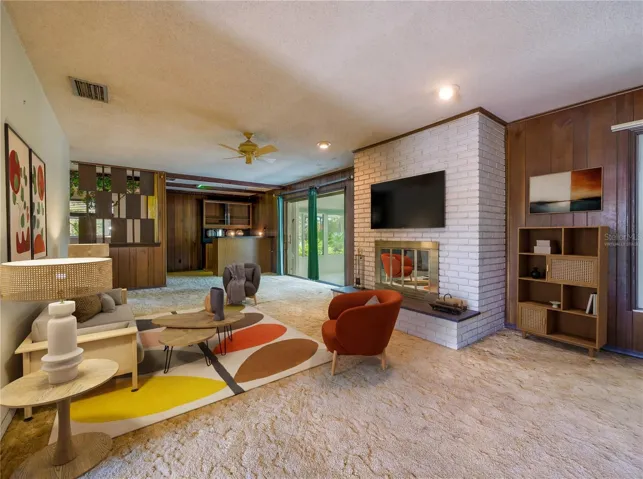 Virtually Staged Living room with brick fireplace and wood paneling