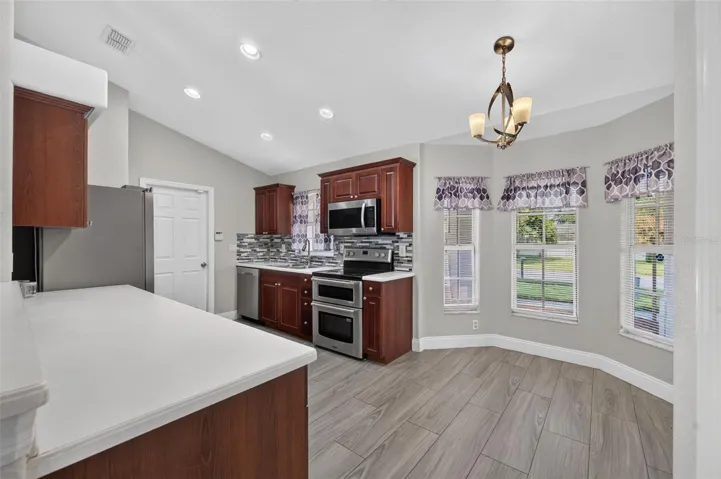 Kitchen nook on right with windows looking out front