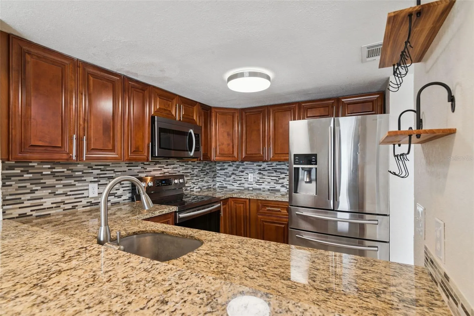 Kitchen with Granite Countertops and new Stainless Steel Appliances