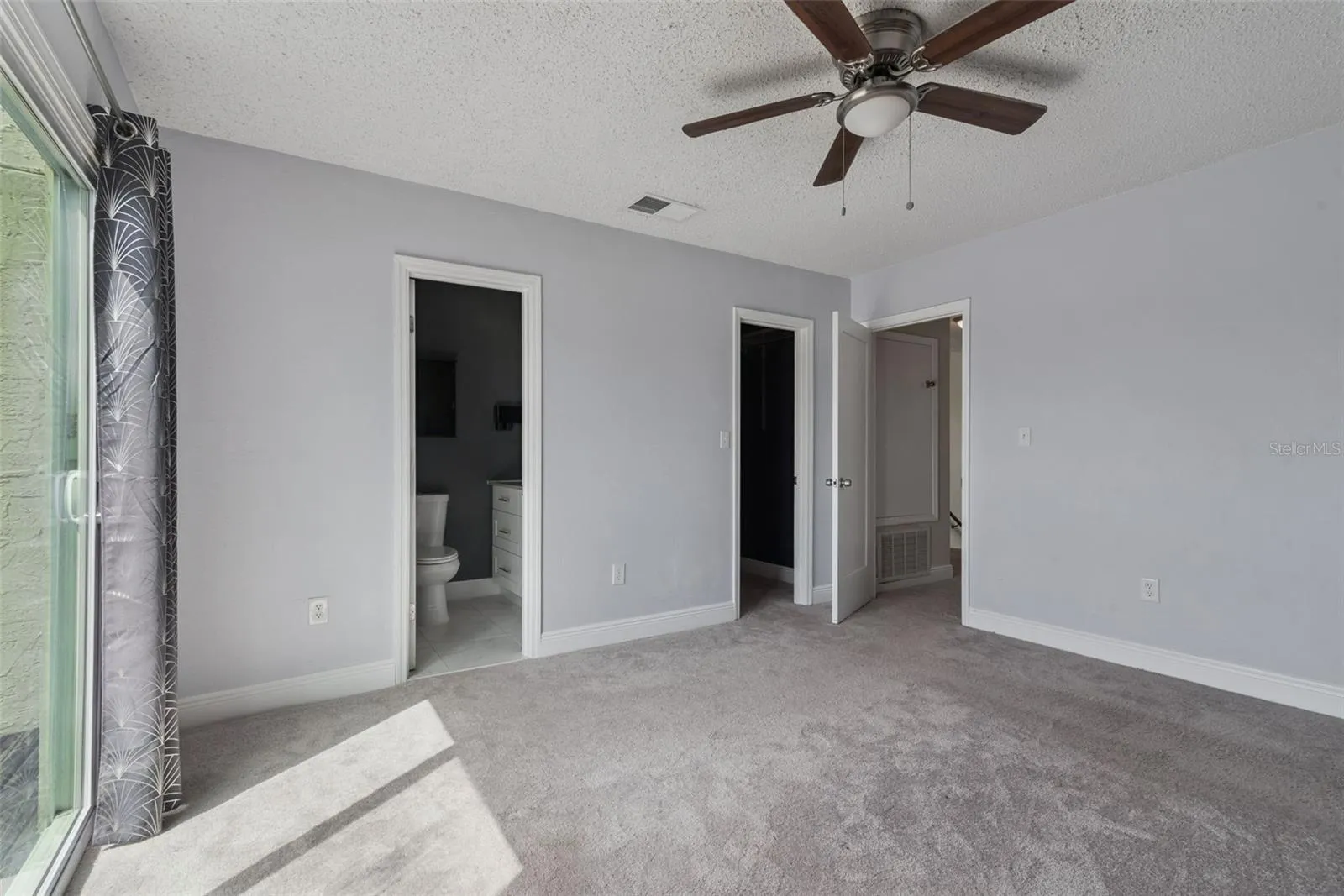 Primary Bedroom with view to primary bathroom and walk-in Closet