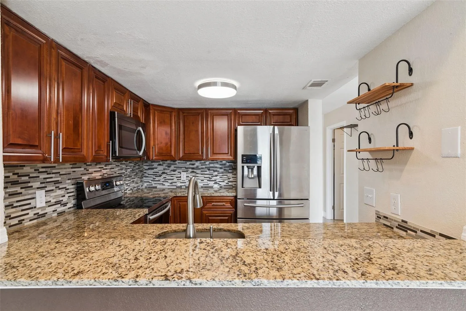 Kitchen with Granite Countertops and new Stainless Steel Appliances