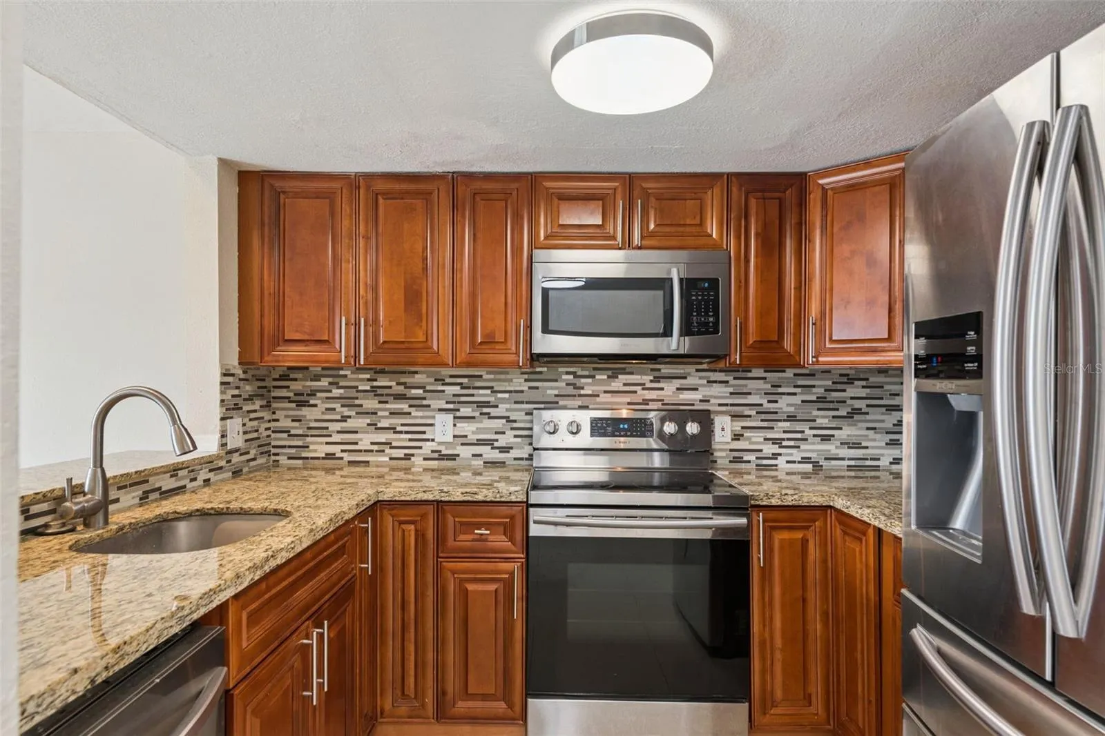 Kitchen with Granite Countertops and new Stainless Steel Appliances