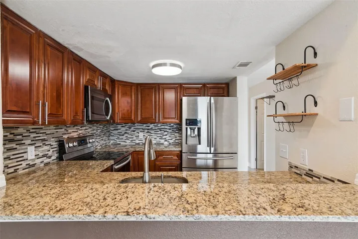 Kitchen with Granite Countertops and new Stainless Steel Appliances