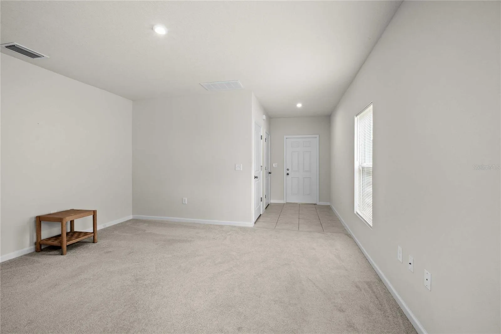 The entry foyer is tiled and has a hall closet with garage access.