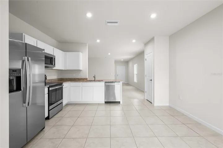 The kitchen can accommodate a large table or an island if you prefer