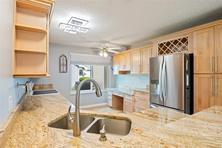 Updated kitchen with granite counter tops, built in desk, large pantry cabinet.