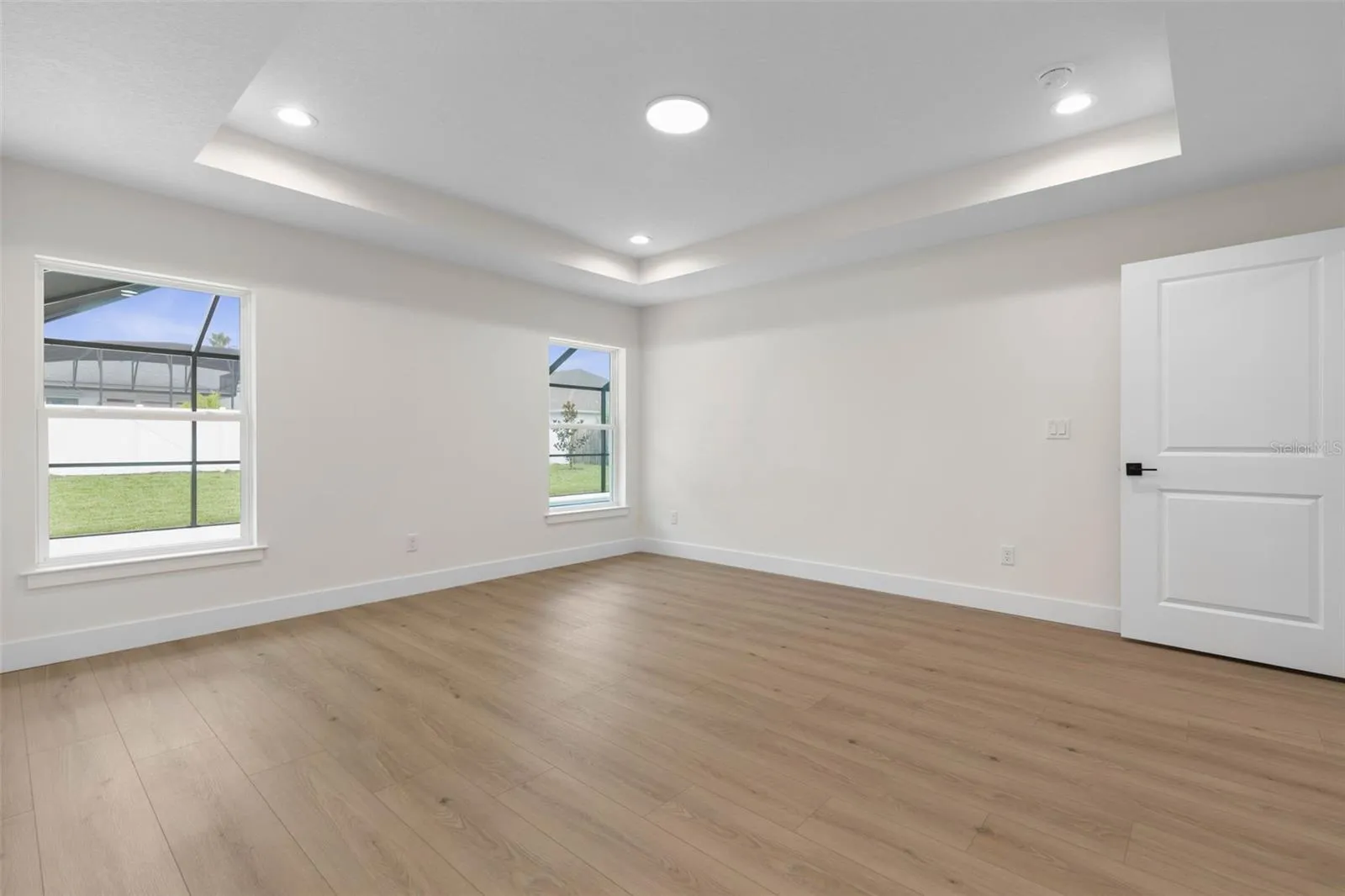 Primary bedroom looking to pool