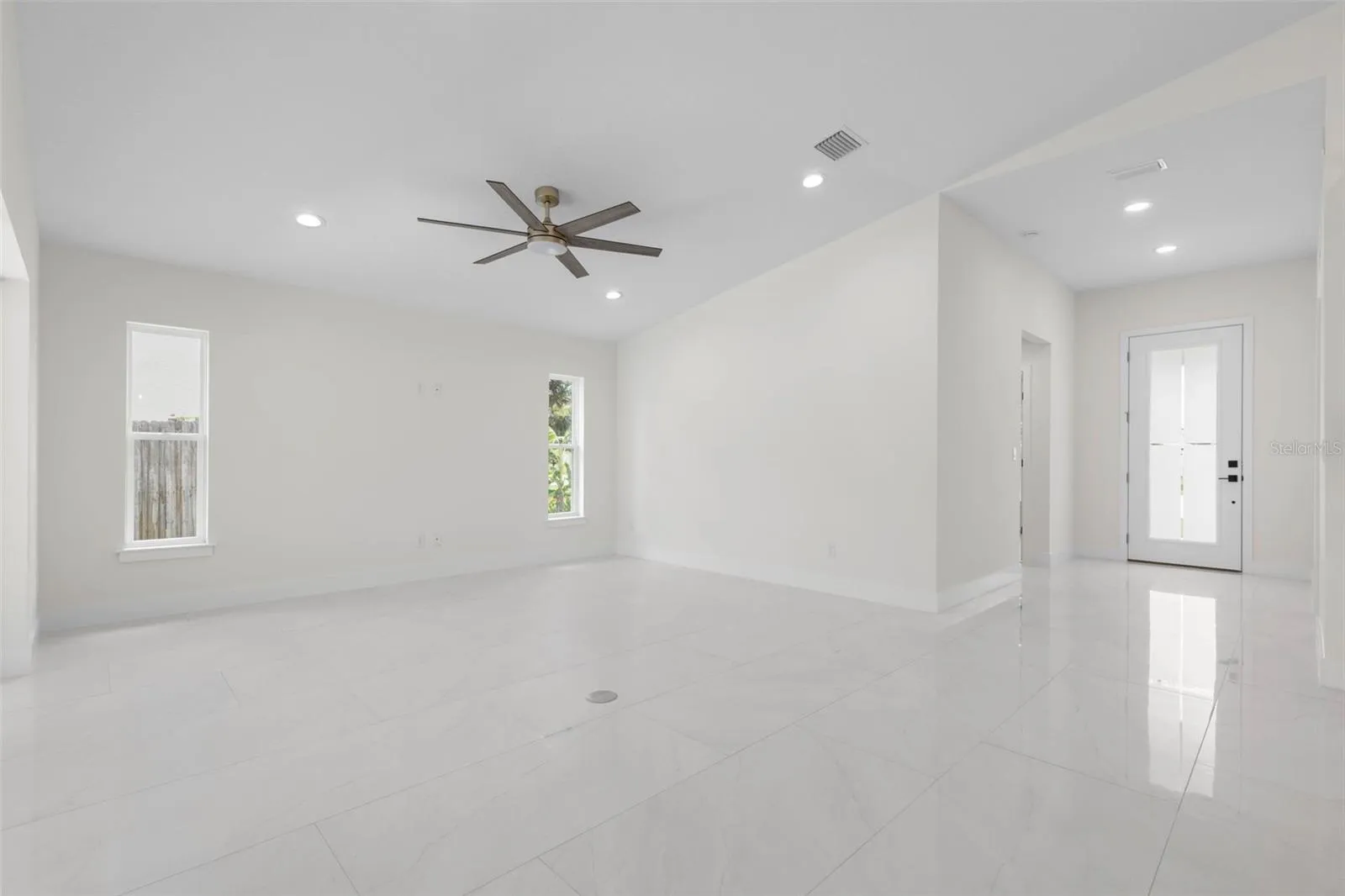 Spacious entry with high ceiling and 8' entry door