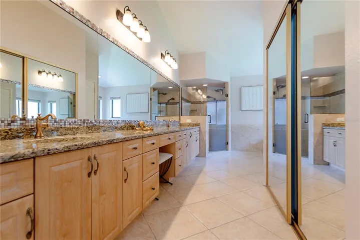 Primary en-suite bathroom with dual sinks.
