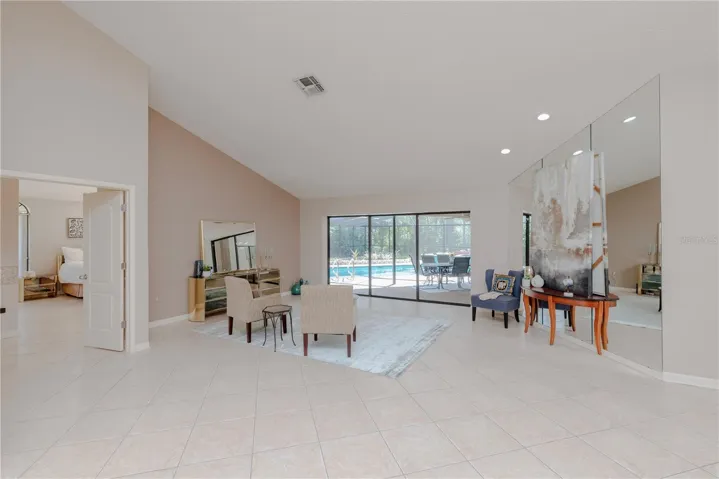 Greeted by volume ceilings with a pool view.
