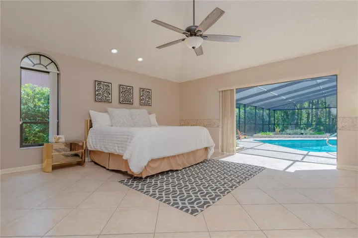 Primary bedroom with triple slider to pool lanai.