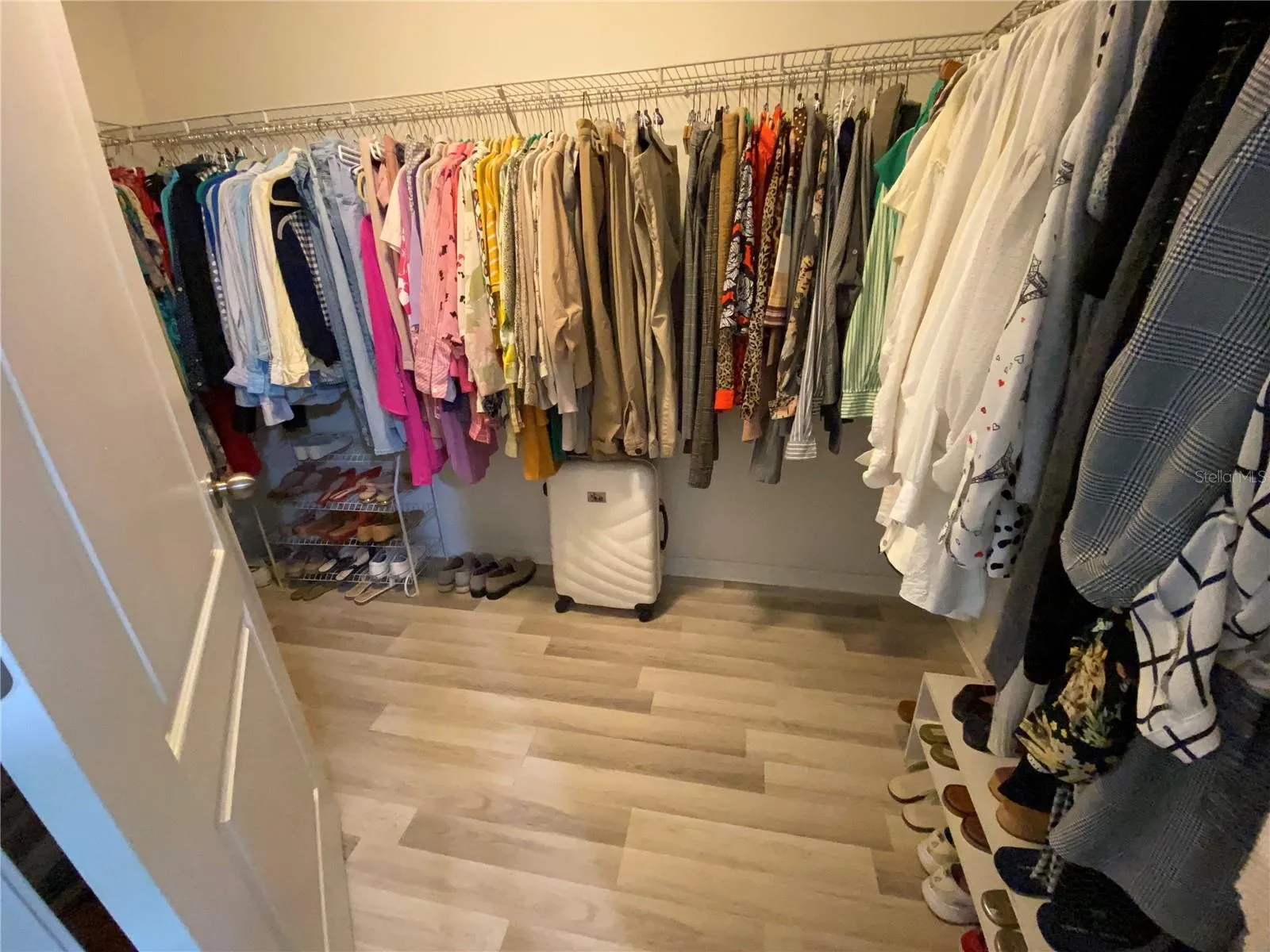 Primary bedroom walk in closet