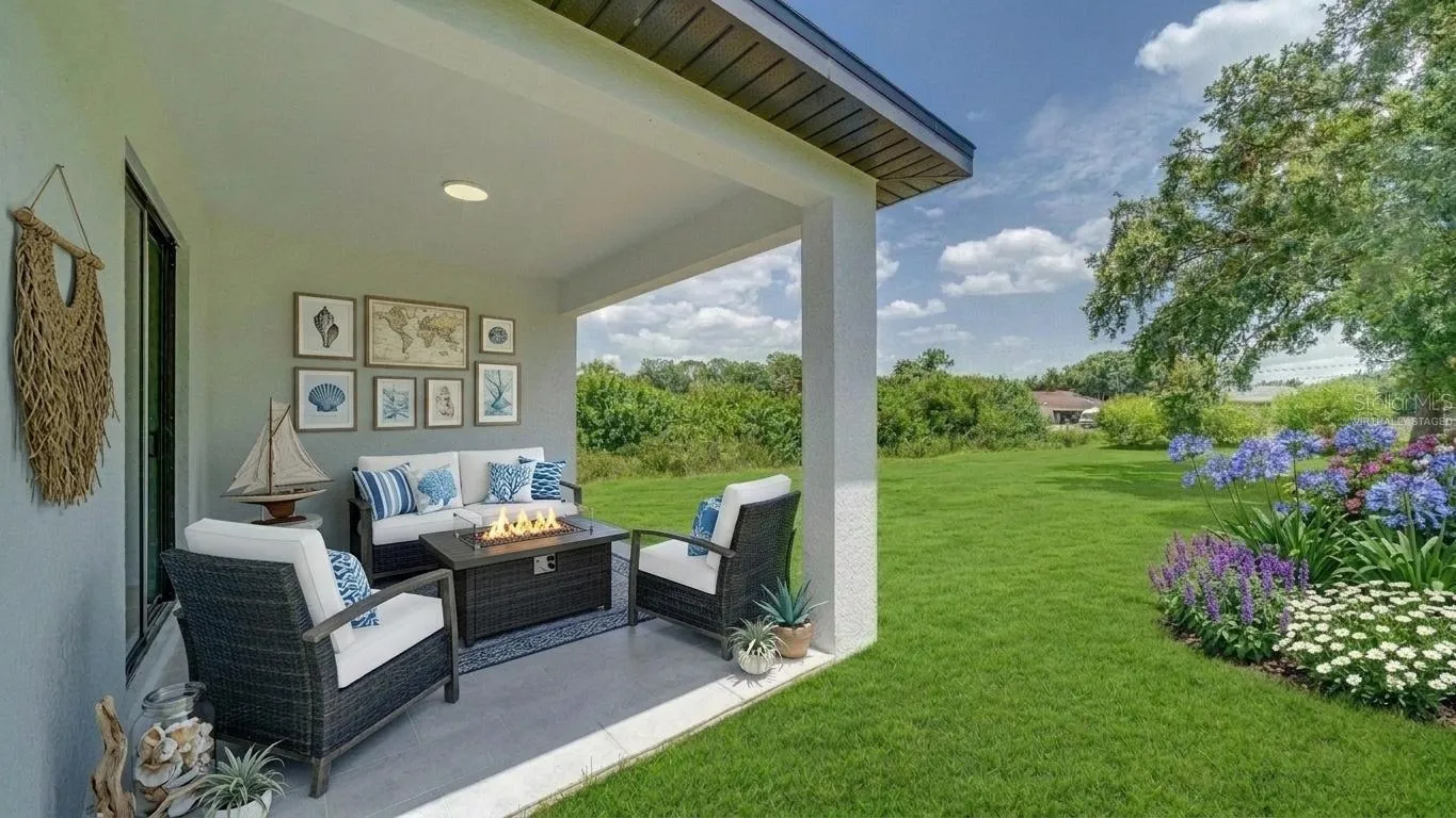 Another view of the lanai and backyard. No neighbor in the back! (Virtually staged &amp; enhanced)