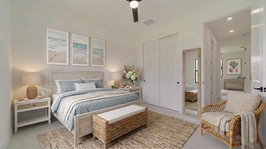 Front guest Bedroom (Virtually Staged) Hallway behind chair leads to bathroom & bathroom & another guest bedroom.