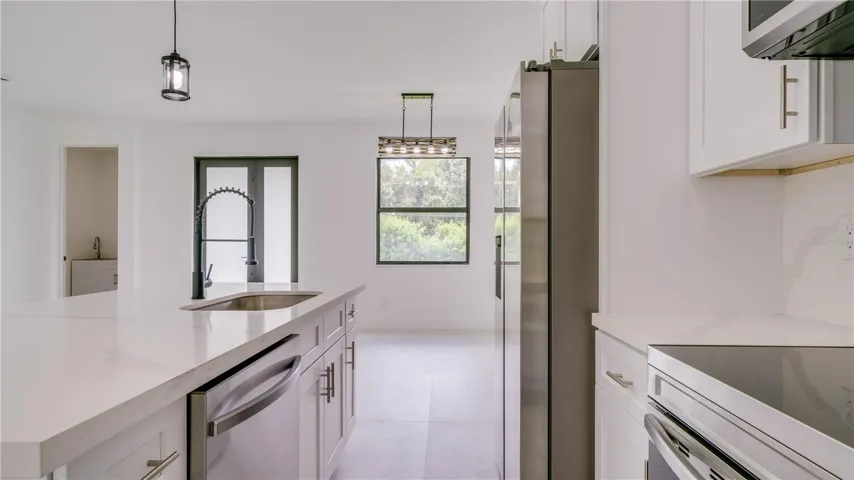 View from kitchen of front door. Laundry room is to the left. Dining area straight ahead.