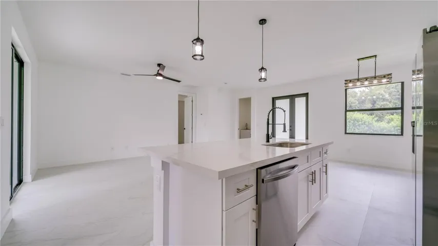 Another view from the kitchen showing the great room. Door on far wall leads to the Primary En-suite!