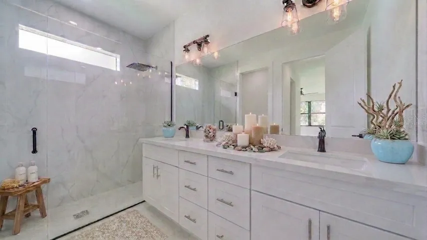 Dual vanity/sinks with a gorgeous all tile walk-in rain shower! (Virtually staged)