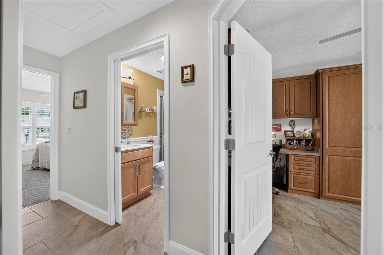 Hallway showing doors to both guest bedrooms and guest bathroom