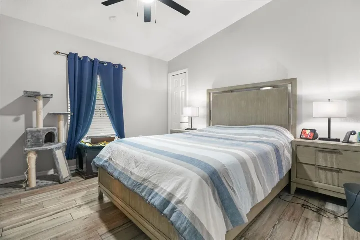 2nd bedroom with volume ceilings and upgraded tile flooring.
