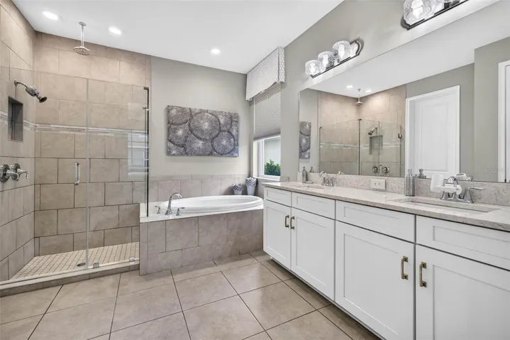First floor primary ensuite bath with tub and shower.