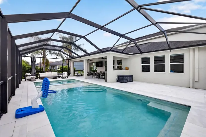 Pool with hot tub, sun deck, outdoor kitchen, and upgraded deck.