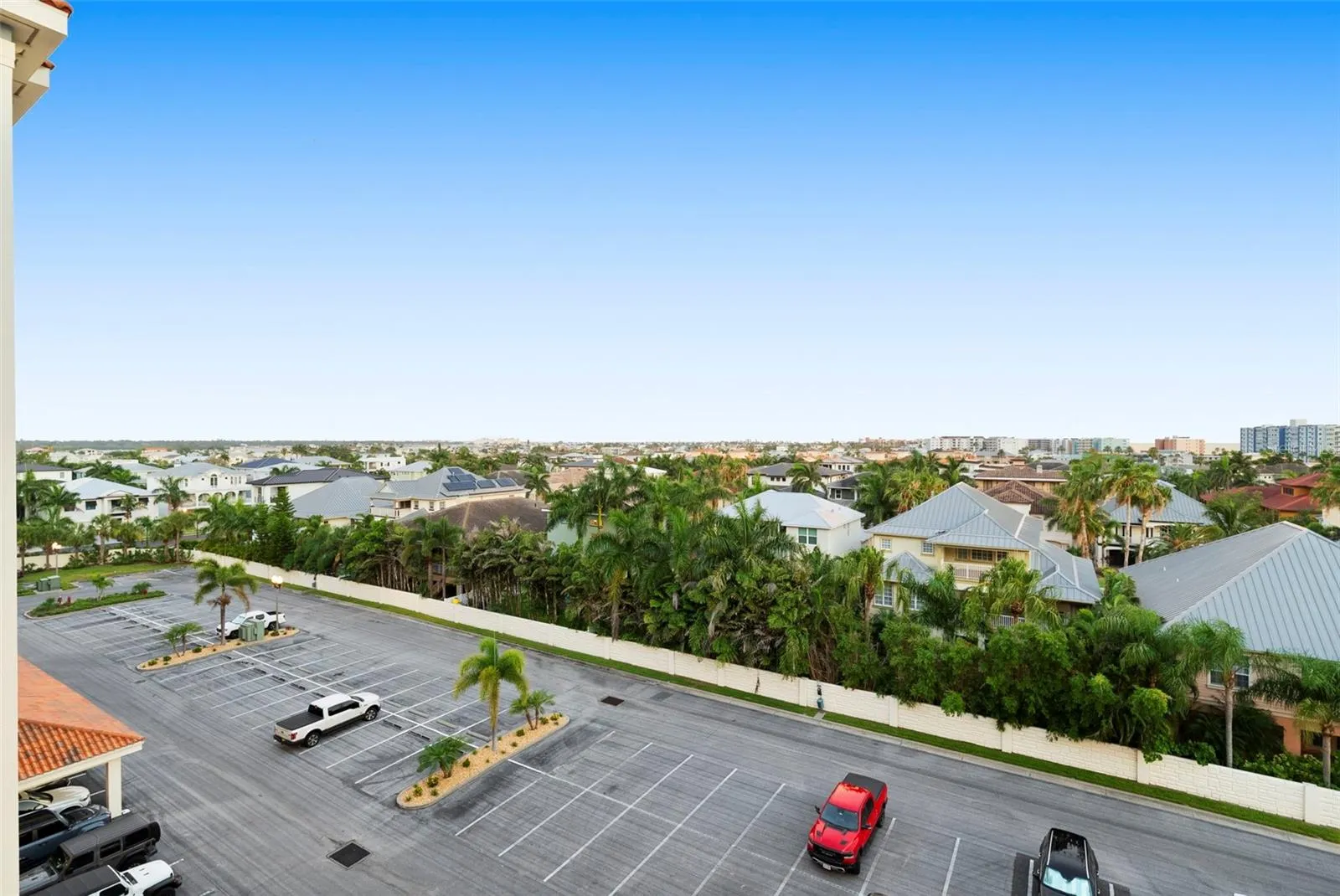 Front view from units door to parking lot of front with PLENTY IF GUEST PARKING , which is rare for beach communities. Enjoy gatherings from friends and family with secured parking lot , carports avail and under building assigned parking
