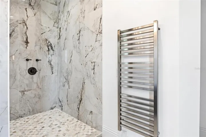 Primary dual walk in shower with heated towel rack