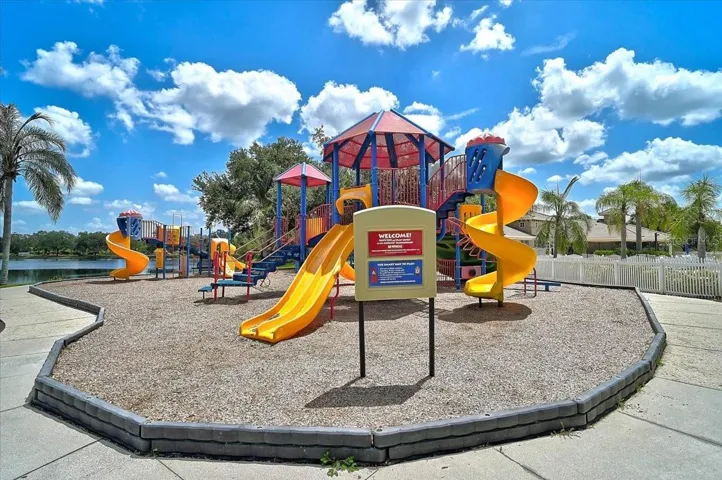 PLAYGROUND AT POOL W/ WATER FEATURES AND SLIDE