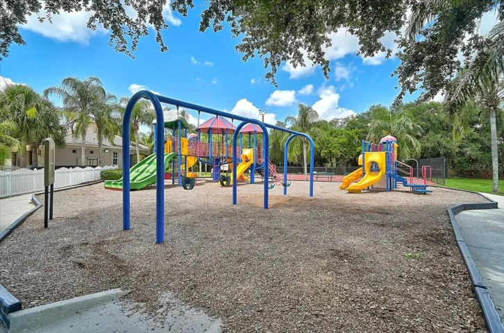 PLAYGROUND AT POOL W/ WATER FEATURES AND SLIDE