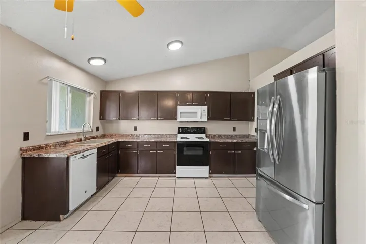 Open spacious kitchen with stainless steel refrigerator