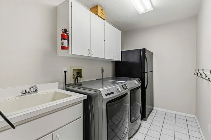 Separate Laundry Room with sink, washer & dryer and extra refrigerator