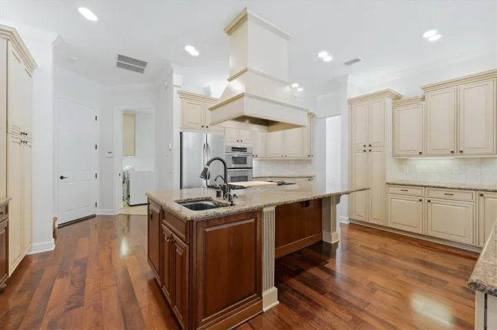Spacious kitchen with granite counters and wood floors