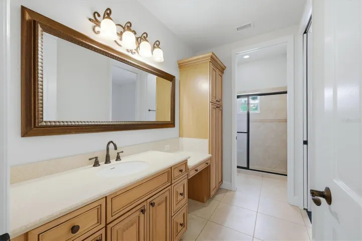 Large bathroom with dual-sink vanity and abundant storage