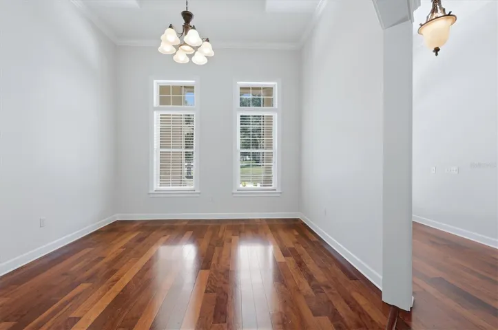 Formal dining room with crown molding and wood floors