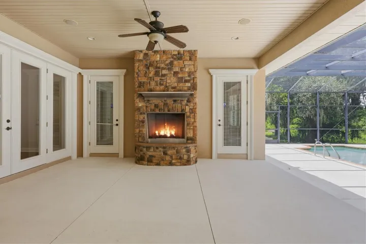 Covered lanai with outdoor fireplace and entertaining space