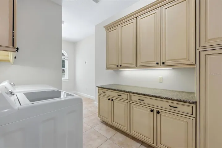 Laundry room with utility sink and built-in cabinetry