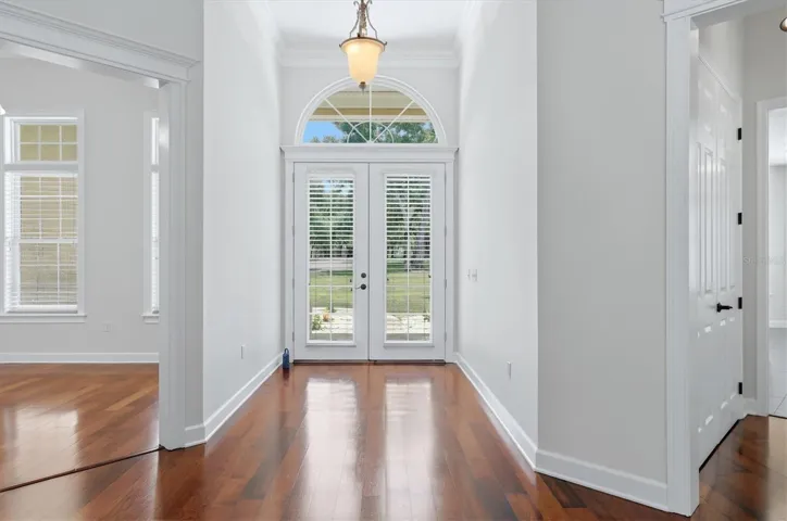 Bright formal entry with hardwood flooring