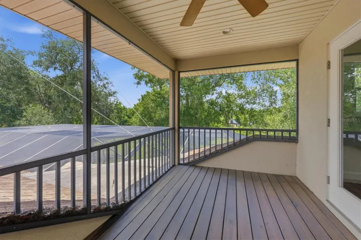 Covered screened balcony overlooking the wooded property