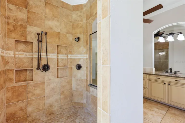 Oversized tiled walk-in shower in primary bathroom