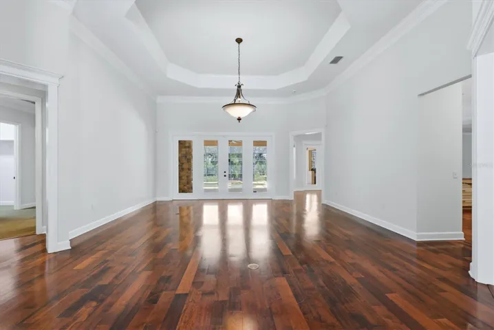 Elegant interior room with tall windows and wood floors