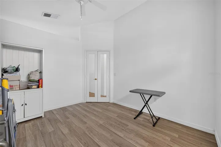 Office in front of home with lovely front window flooding with natural light and glass French doors