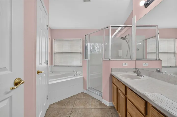 Large primary suite bathroom with large soaking jet tub and huge shower