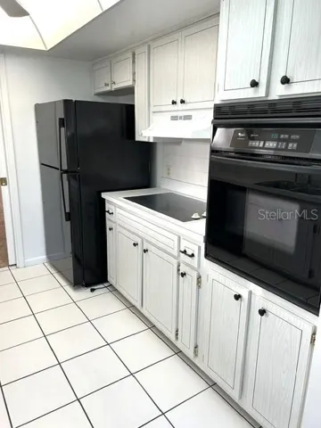 Kitchen w/newer fridge,countertop range and wall oven