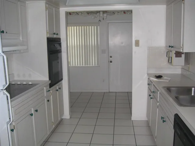Galley kitchen w/plenty of cabinets