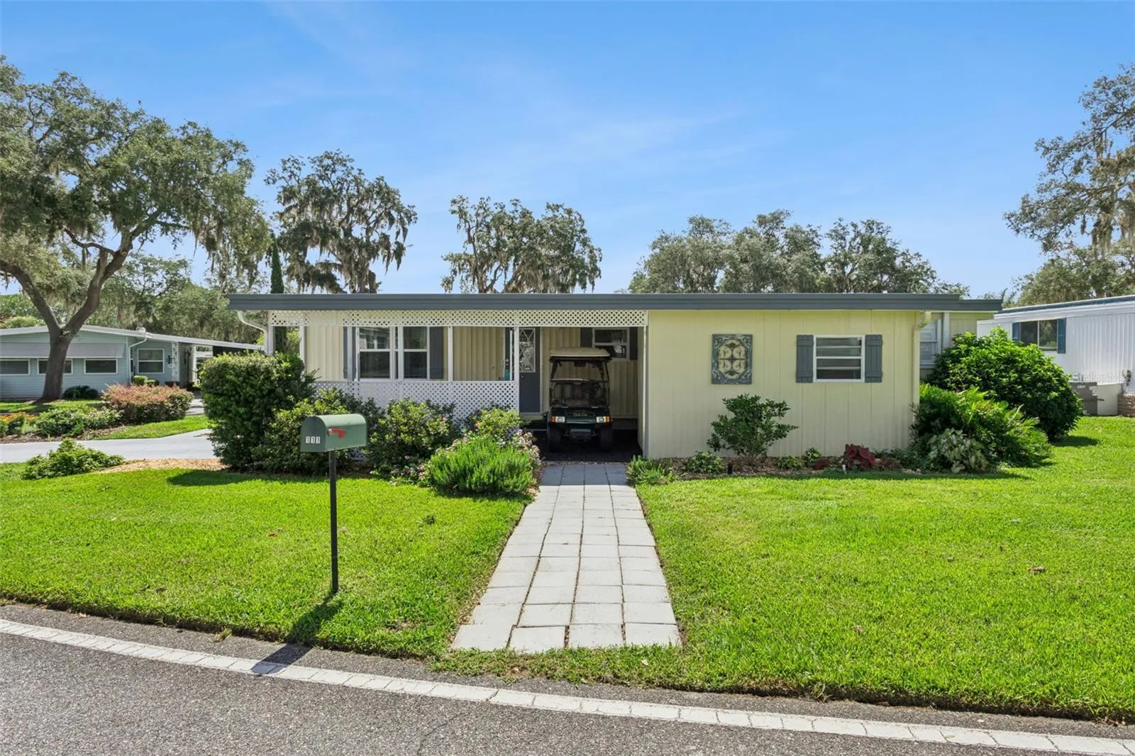 The carport has a separate access for the golf cart and the GOLF CART IS INCLUDED!
