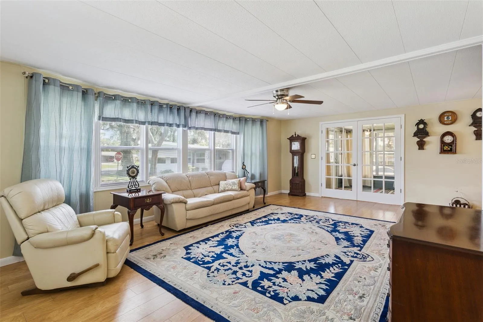 LIVING ROOM has oodles of windows plus FRENCH DOORS that lead to the LANAI.