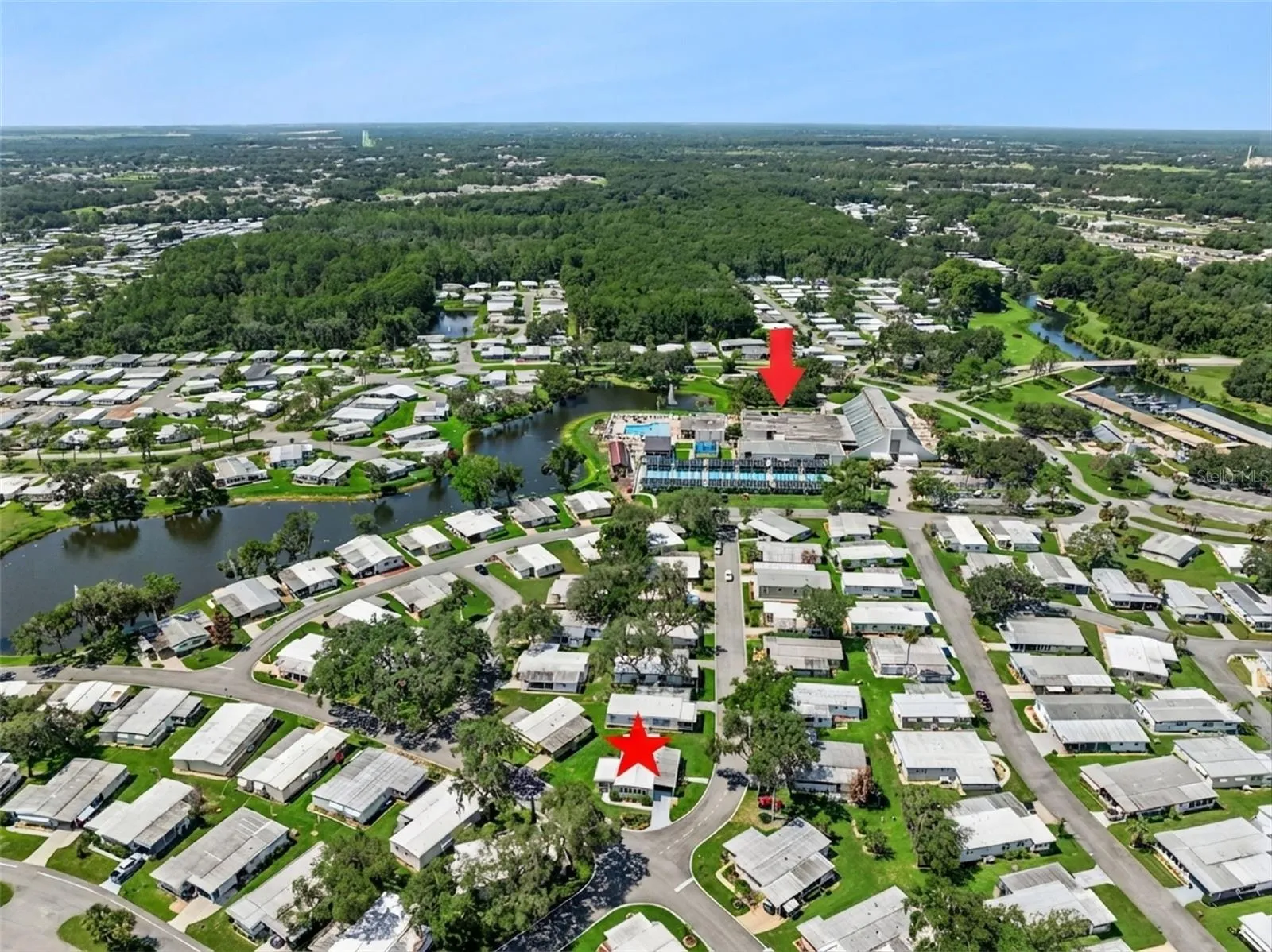 You can walk to the Recreation Center (red arrow) from this home (red star) OR DRIVE BY GOLF CART THAT IS INCLUDED WITH THE HOME!